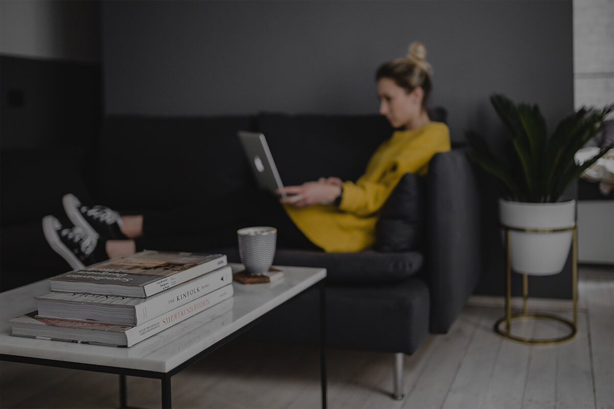 online booking with laptop on sofa